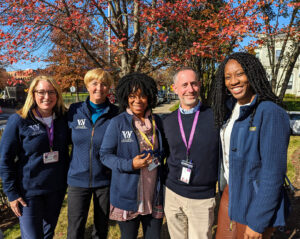 The College Counseling team poses for a group photo outside.