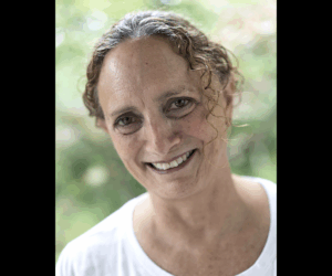 A photo of Judith Salomon smiling at the camera.