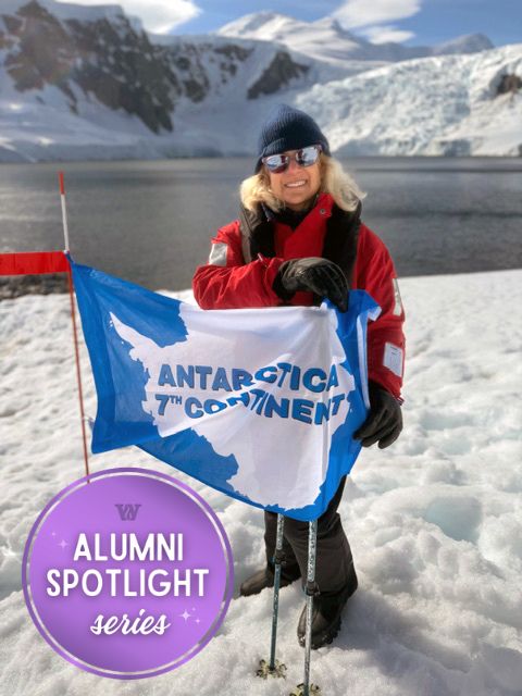 Wilson Kimball '86 stands in Antarctica while holding a white and blue flag that reads: "Antarctica - 7th Continent
