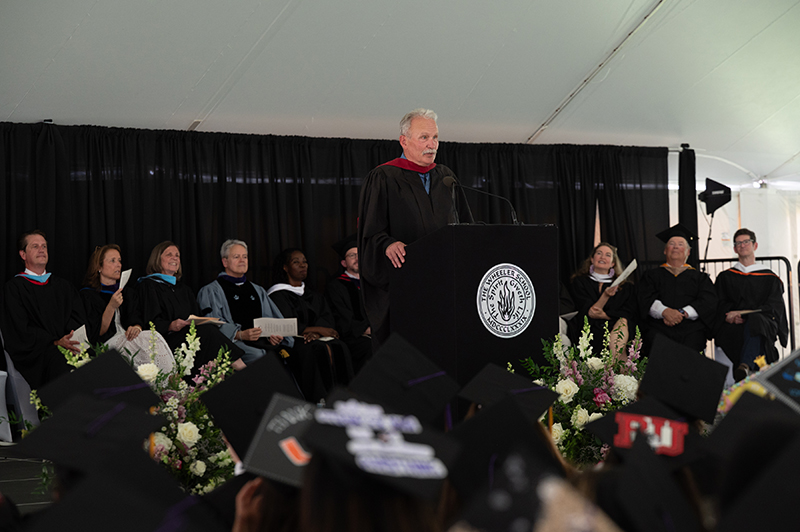 Former Director of the Hamilton School at Wheeler Jon Green speaks at the podium during the 2026 Commencement ceremony.